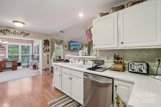 a kitchen with a sink cabinets and window