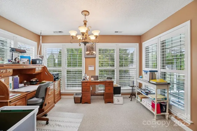 a bedroom with furniture and a large window