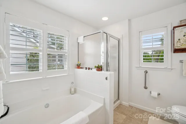 a bathroom with a bathtub and a shower