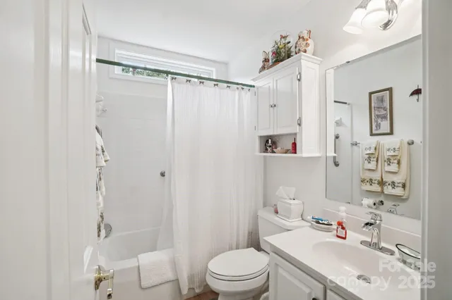a bathroom with a sink toilet tub and shower