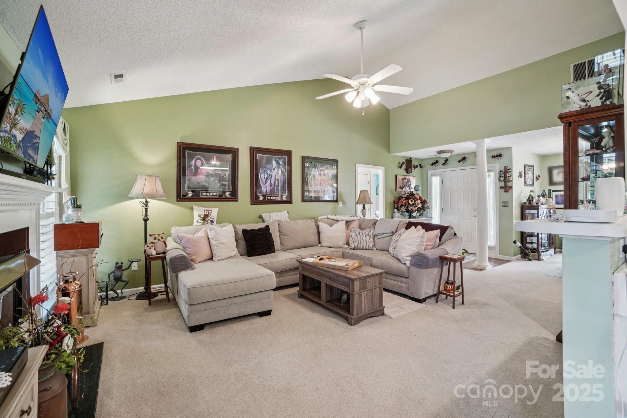 133 Stonehollow Road Fletcher, NC 28732 - Photo 6 of 29 a living room with furniture a flat screen tv and a fireplace
