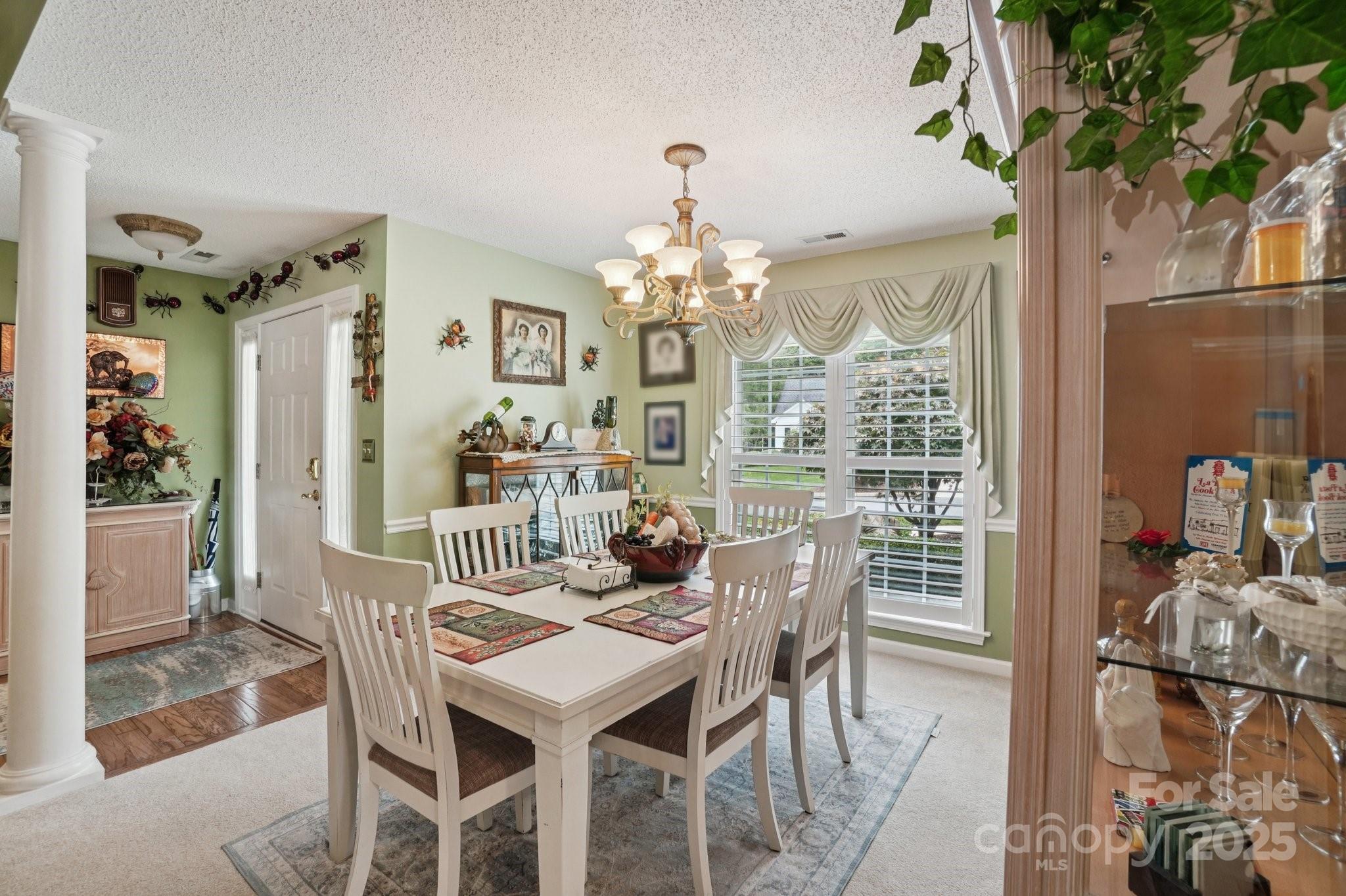 133 Stonehollow Road Fletcher, NC 28732 - Photo 8 of 29 a view of a dining room with furniture wooden floor and chandelier