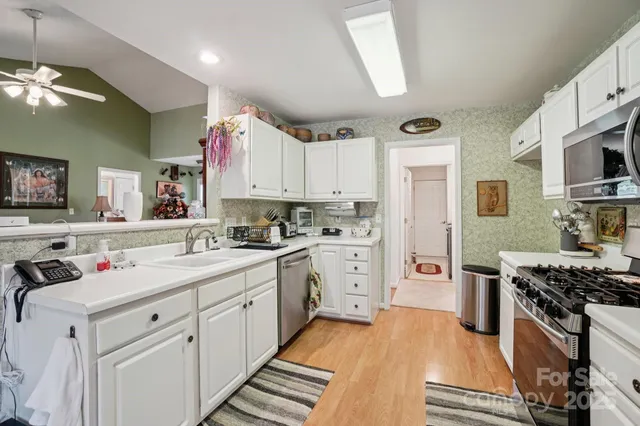 a kitchen with cabinets appliances and a counter