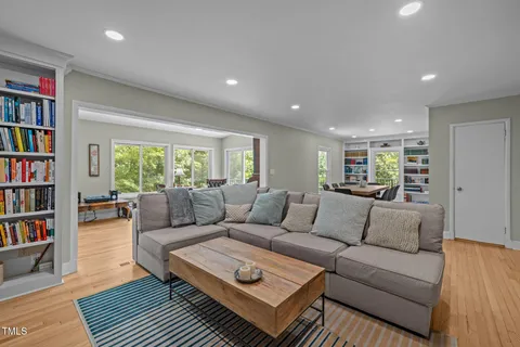 a living room with a fireplace and a book shelf
