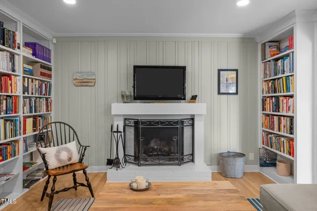 a living room with furniture and large windows