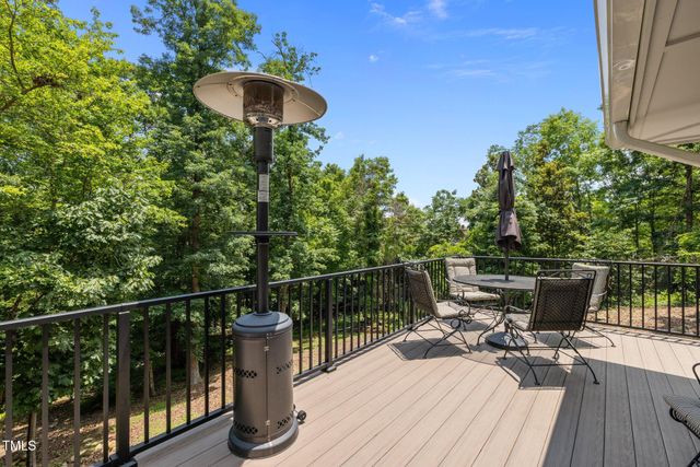 a terrace with outdoor seating and trees