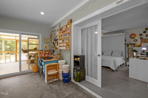 a bedroom with furniture and a large window