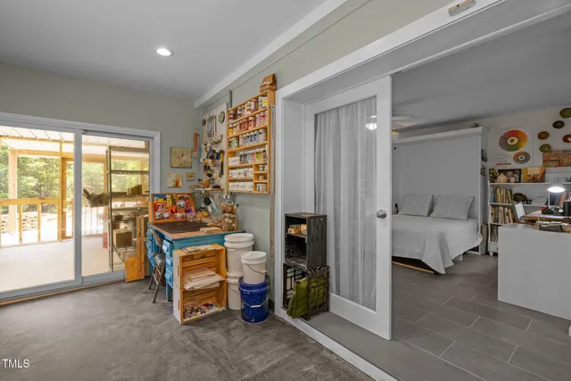 a bedroom with furniture and a large window