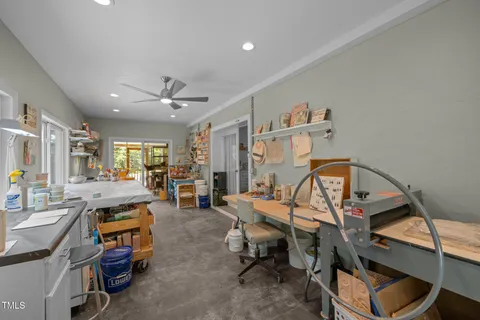 a living room with furniture a flat screen tv and gym equipment