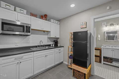 a kitchen with stainless steel appliances granite countertop a refrigerator sink and stove