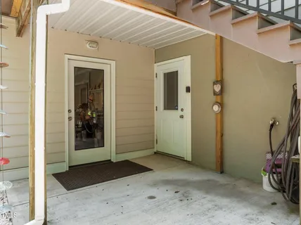 a view of a hallway with wooden walls and door