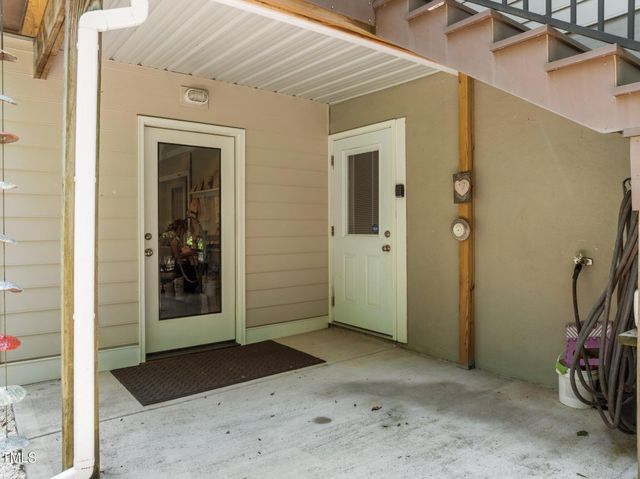 a view of a hallway with wooden walls and door