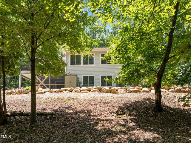 a wooden bench sitting in front of a house