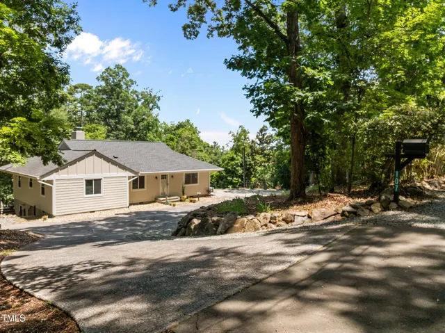 a view of a house with a tree in the background
