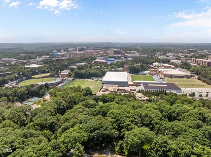 an aerial view of residential building with green space