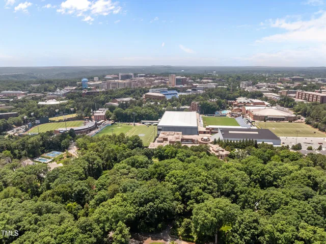 an aerial view of residential building with green space
