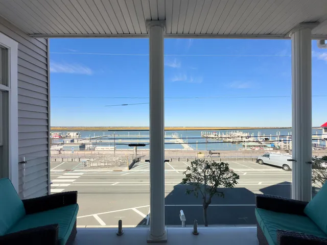 a view of a chairs and table in the balcony