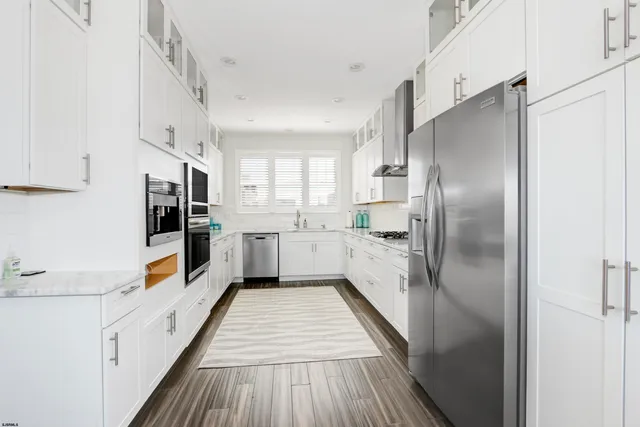 a kitchen with stainless steel appliances granite countertop a stove and a sink