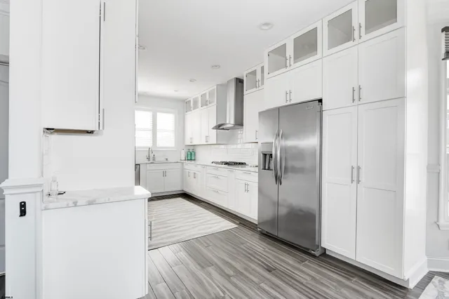a kitchen with granite countertop white cabinets and white appliances