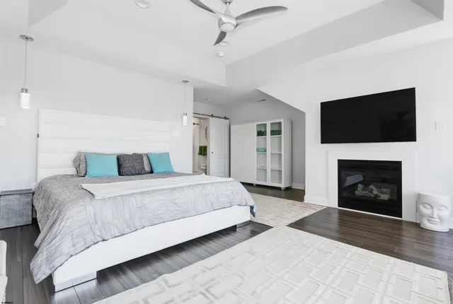 a bathroom with a granite countertop shower sink vanity mirror and bathtub