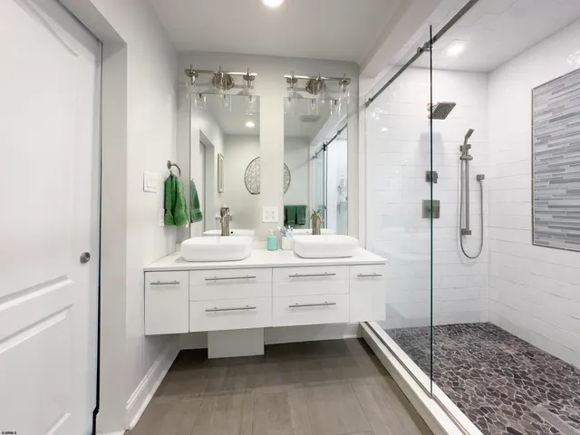 a bathroom with a sink a toilet and a shower