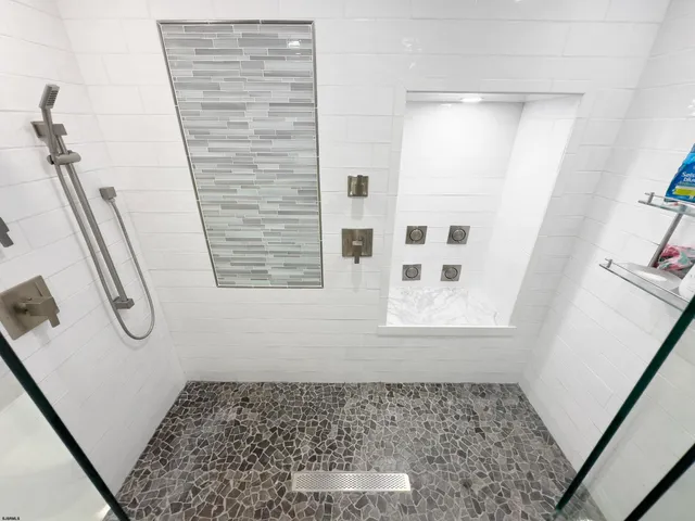 a bathroom with a toilet a sink and shower