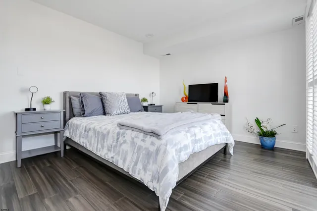 a bathroom with a sink toilet vanity and shower