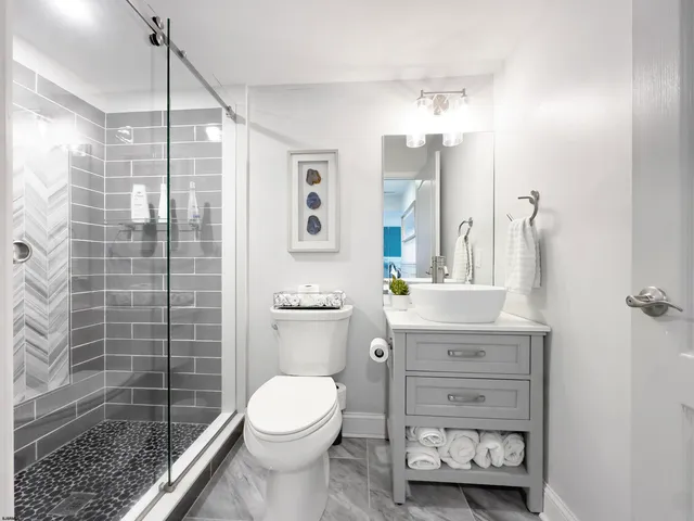 a bedroom with two beds and painting on the wall