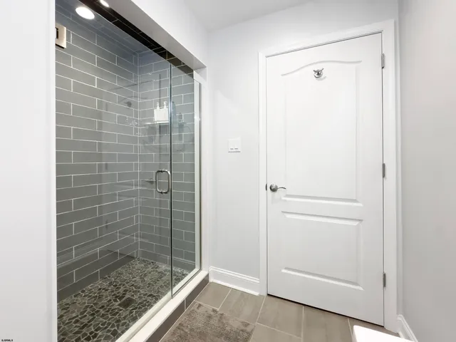 a front view of a building with a garden and entryway