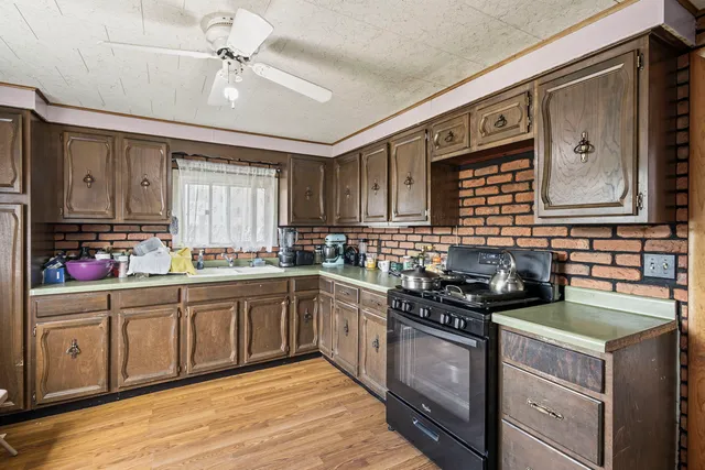 a kitchen with stainless steel appliances granite countertop a stove sink and cabinets