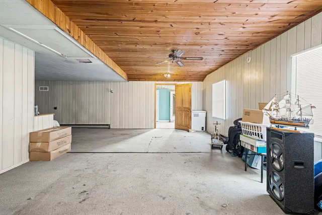 a spacious bedroom with a bed and a chandelier