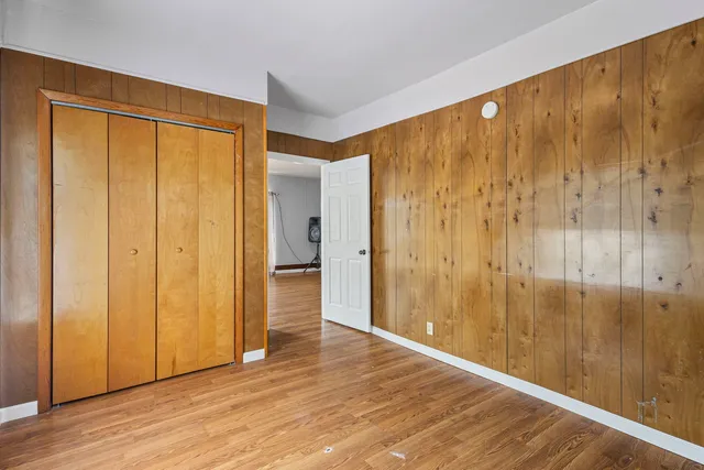 a view of an empty room and wooden floor