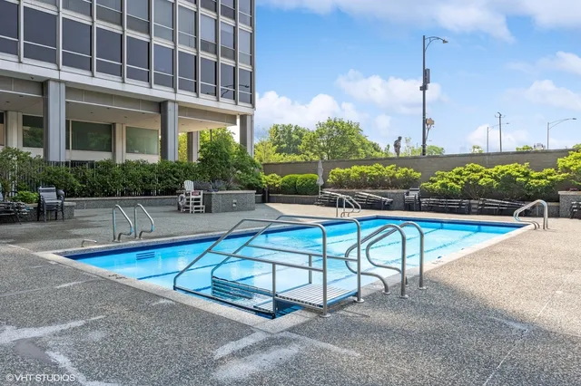 a view of a swimming pool with a lounge chairs