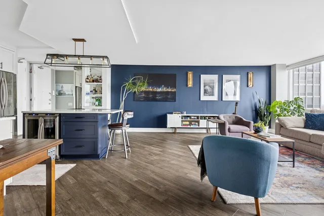 a living room with furniture a flat screen tv and a table