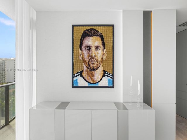 a large bedroom with a large bed and glass window