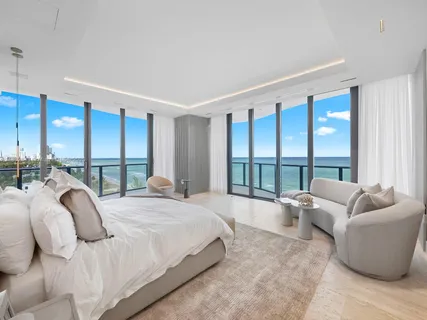 a living room with furniture and a floor to ceiling window