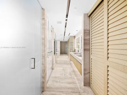 a view of a room with gym equipment and floor to ceiling window