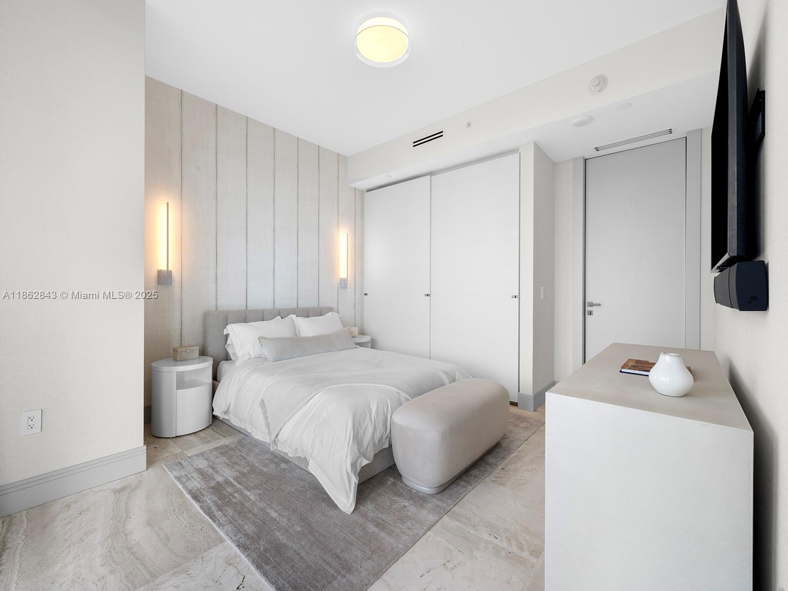 19575 Collins Avenue, Unit 9 Sunny Isles Beach, FL 33160 - Photo 49 of 91 a bedroom with a bed and a flat screen tv