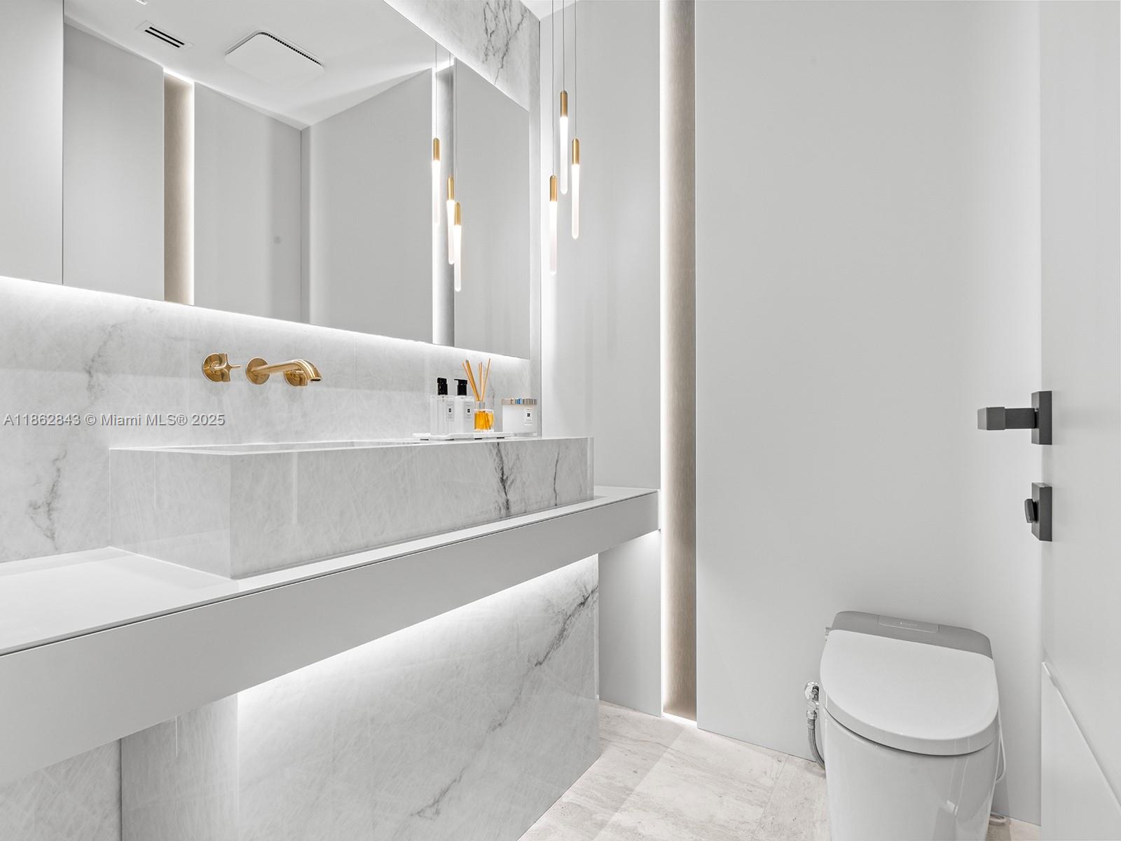 19575 Collins Avenue, Unit 9 Sunny Isles Beach, FL 33160 - Photo 56 of 91 a bathroom with a sink a toilet and bathtub