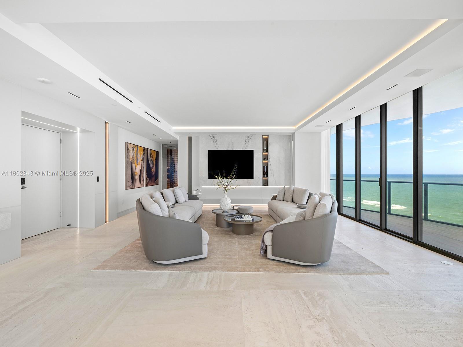 19575 Collins Avenue, Unit 9 Sunny Isles Beach, FL 33160 - Photo 6 of 91 a living room with furniture and a flat screen tv