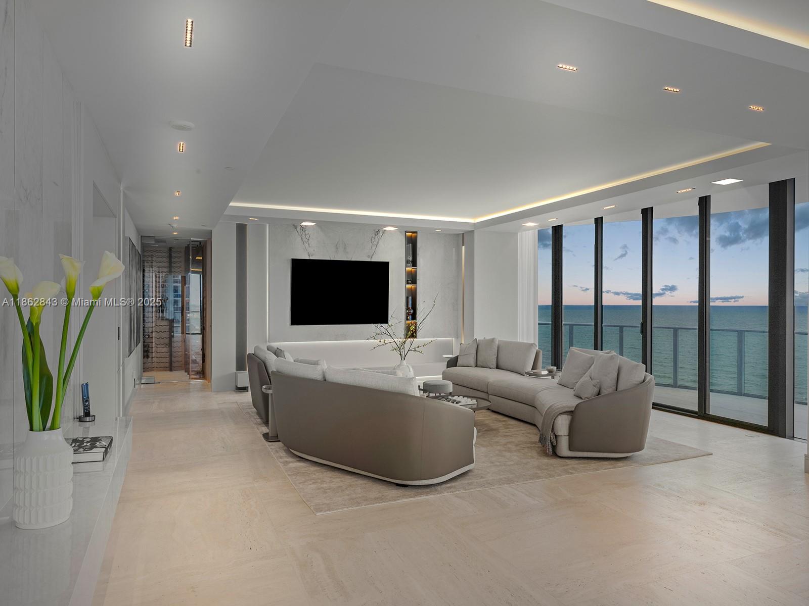 19575 Collins Avenue, Unit 9 Sunny Isles Beach, FL 33160 - Photo 9 of 91 a living room with furniture and a flat screen tv