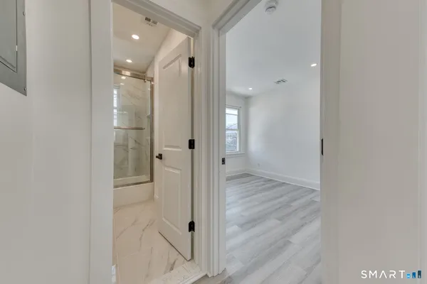 a view of a bathroom from a hallway