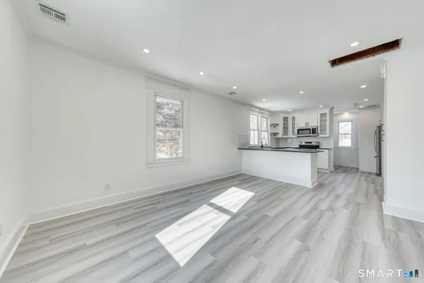 a view of kitchen view with wooden floor and windows