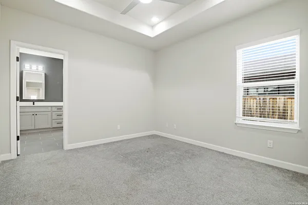 an empty room with windows and cabinet