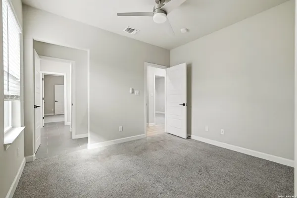 an empty room with fan and entrance