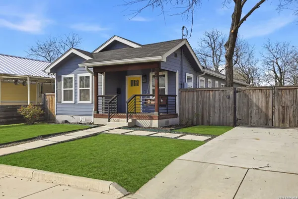 a front view of a house with a garden and yard