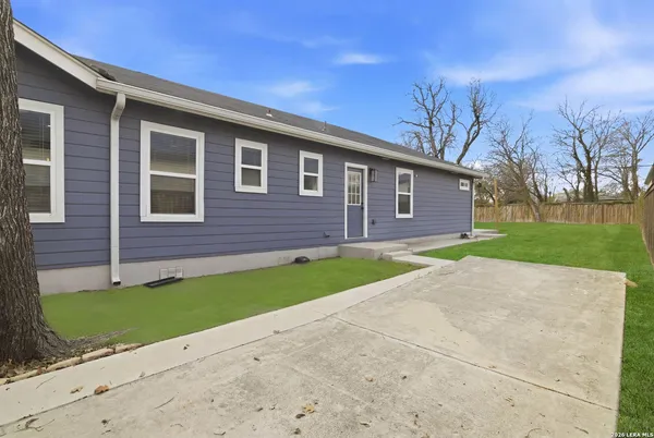 a front view of a house with a garden and yard