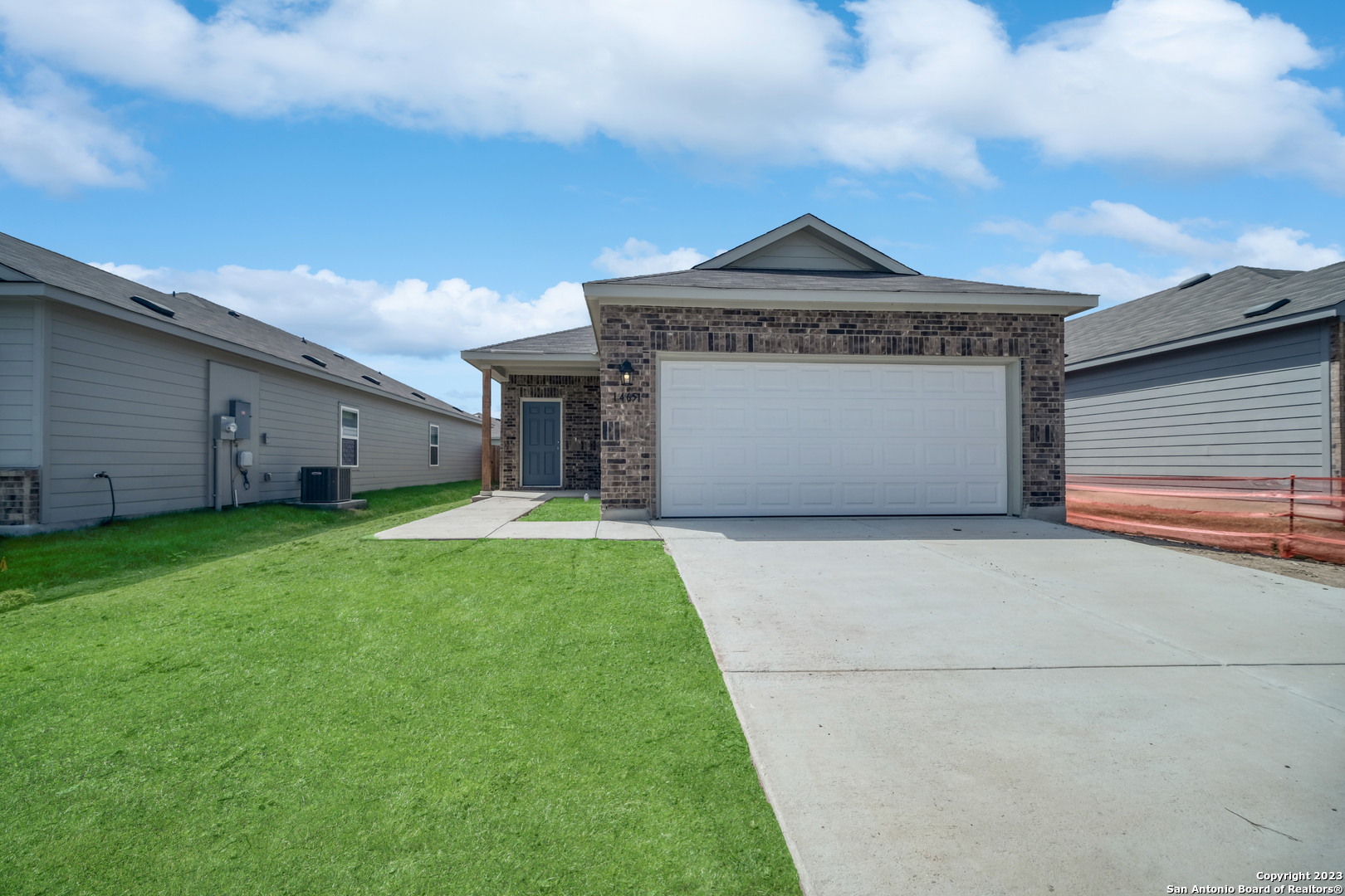 14651 Hackamore Way Elmendorf, TX 78112 - Photo 1 of 1 a front view of a house with a garden and garage