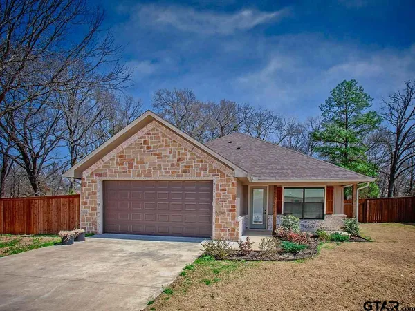 a front view of house with yard outdoor seating and barbeque oven