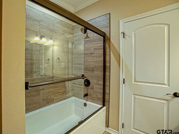 a bathroom with a shower and a bath tub